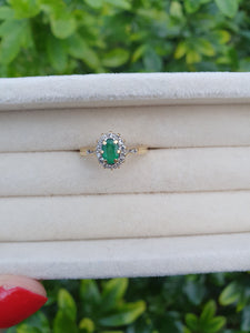 7007:Vintage: 18ct Gold Oval Emerald 14 Brilliant Cut Diamonds Cluster Ring- lovely quality, hallmarked in London