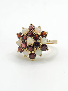 1596: Vintage:&nbsp; 9ct Gold White Opals Red Garnets Flowerhead Cluster Ring- From 1972