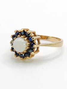 2090: Vintage; 9ct Gold White Opal 12 Blue Sapphires Flower head Ring- From 1976