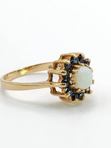 2090: Vintage; 9ct Gold White Opal 12 Blue Sapphires Flower head Ring- From 1976