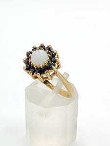 2090: Vintage; 9ct Gold White Opal 12 Blue Sapphires Flower head Ring- From 1976