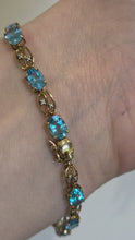Load and play video in Gallery viewer, 2110: Vintage 9ct Gol Swiss Blue Topaz Diamonds Bracelet (18.5cm)
