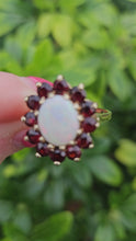 Load and play video in Gallery viewer, 0775: Vintage: 9ct Gold White Opal Red Garnets Flower- Head Cocktail Ring- Date-Mark 1977
