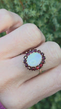 Cargar y reproducir el video en el visor de la galería, Vintage: Classic 9ct Gold White Opal 14 Red Garnets Flower Head Ring
