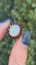 Cargar y reproducir el video en el visor de la galería, Vintage: Classic 9ct Gold White Opal 14 Red Garnets Flower Head Ring
