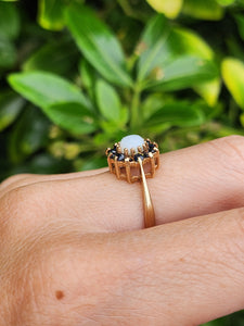 2090: Vintage; 9ct Gold White Opal 12 Blue Sapphires Flower head Ring- From 1976