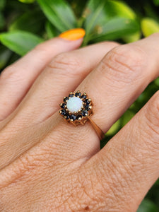 2090: Vintage; 9ct Gold White Opal 12 Blue Sapphires Flower head Ring- From 1976